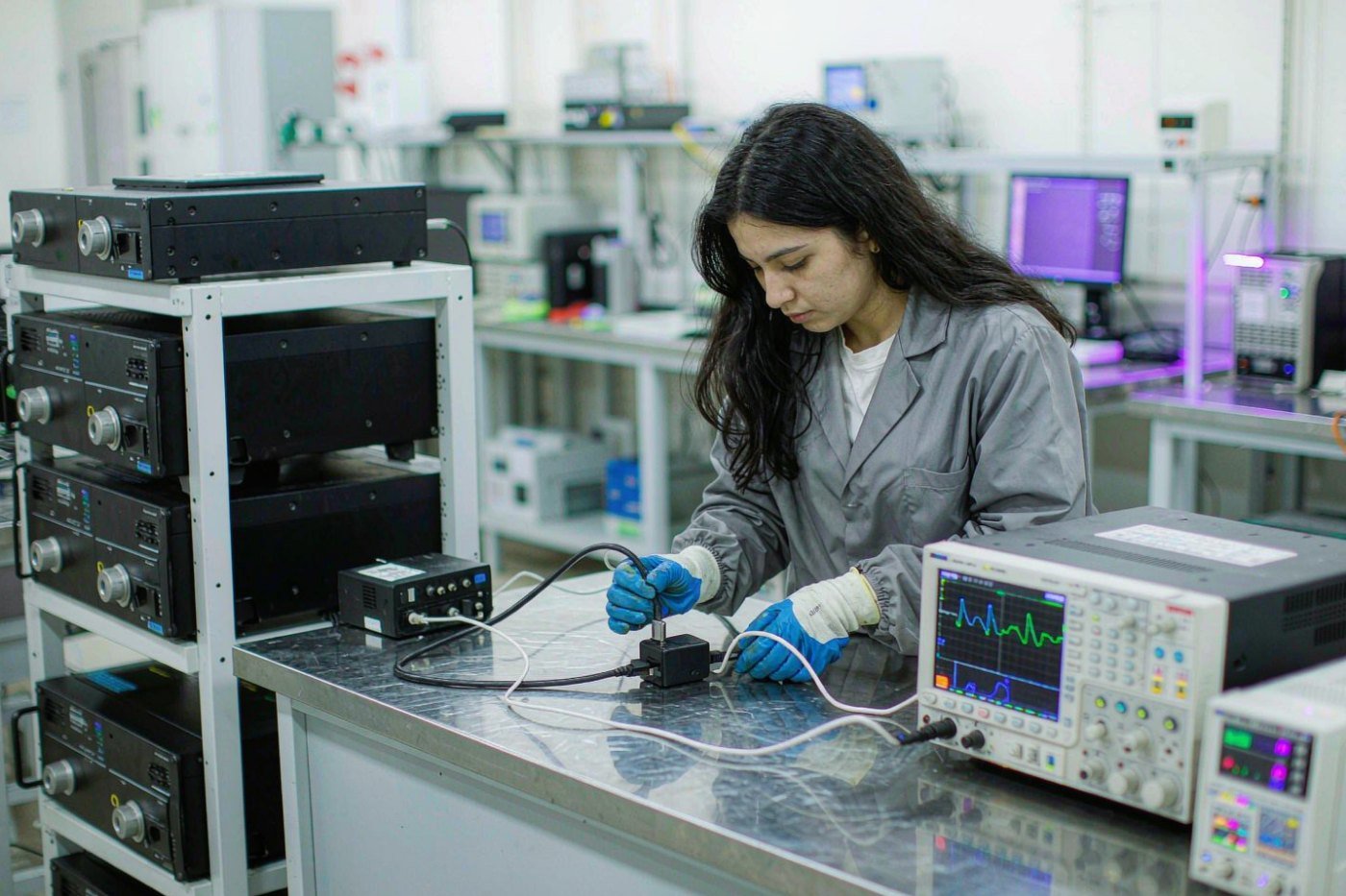 Engineer testing a USB-C charger with an oscilloscope in the QC lab
